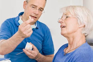 denturist with senior patient