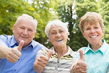 senior couple brushing their teeth